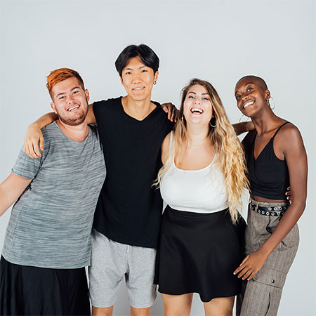 four people smiling at camera